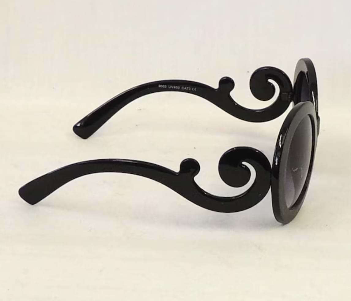Side view of Ariana retro sunglasses with black swirl temple arms and round black frames.